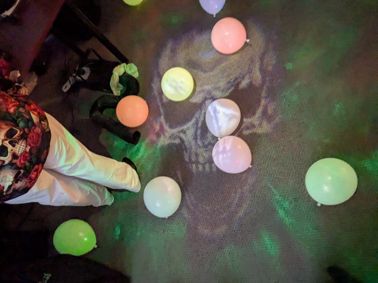 Floor with a scary skull and green fire projected onto it.