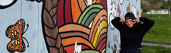 Magalli Standing next to her Mural Posing funny